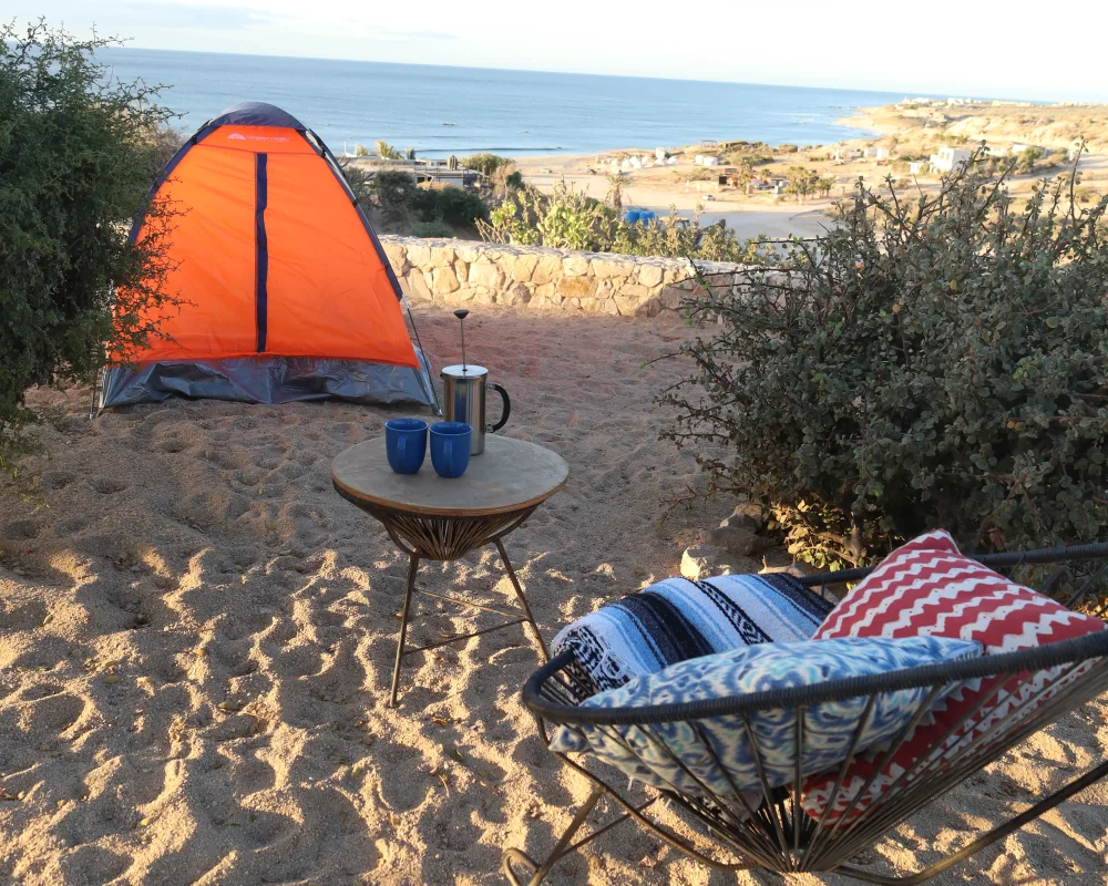Tent camping with coffee and an ocean view at ALAIA Surf Lodge campsite, La Fortuna, East Cape, Baja California Sur
