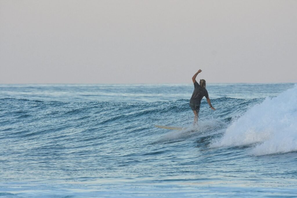 Longboarder on a small wave on the East Cape near ALAIA