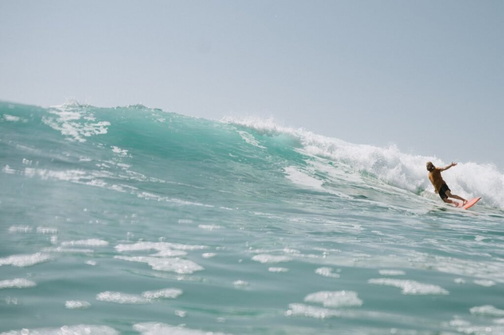 Surfer on an orange board at La Fortuna, East Cape